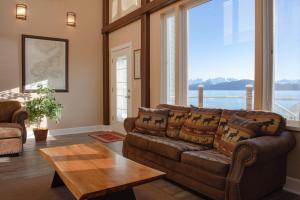 a living room with a couch and a table at Lakeshore Lodging Lodge 709 in Homer