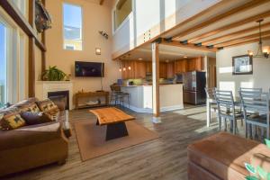 a living room with a couch and a table at Lakeshore Lodging Lodge 709 in Homer