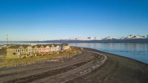 a row of houses on the shore of a body of water at Lakeshore Lodging Lodge 611 in Homer