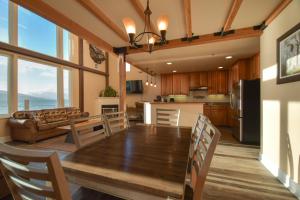 a dining room and kitchen with a table and chairs at Lakeshore Lodging Lodge 709 in Homer +12 photos