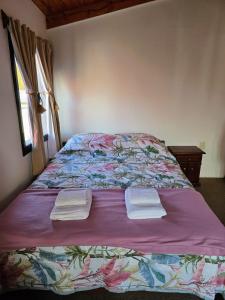 a bed with two towels on top of it at Miniloft Centrico in El Calafate