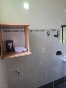 a bathroom with a sink and a towel on a shelf at Miniloft Centrico in El Calafate