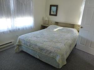 a small bedroom with a bed and a window at Wi-Fi, Patio, Yard, Balcony, Deck, Ocean Side Duplex 1St Floor In Ship Bottom 10609 in Ship Bottom