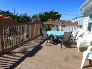a patio with a table and chairs on a deck at Wi-Fi, Patio, Yard, Balcony, Deck, Ocean Side Duplex 1St Floor In Ship Bottom 10609 in Ship Bottom