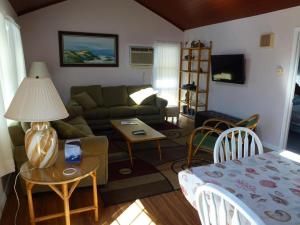 a living room with a couch and a table at Wi-Fi, Patio, Yard, Balcony, Deck, Ocean Side Duplex 1St Floor In Ship Bottom 10609 in Ship Bottom