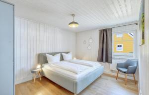 a white bedroom with a bed and a window at 2 Bedroom Nice Home In Zerpenschleuse in Zerpenschleuse +19 photos