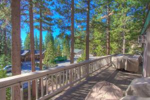 a deck with a table and chairs on it at Gale Force Wind home in Incline Village