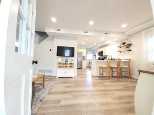 a living room with a kitchen and a dining room at The Sand Star-4BDRM Ventnor Home near Bay & AC in Ventnor City