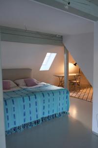 a bedroom with a bed and a table in a room at Atelierhaus in Rehborn