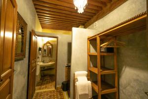 a bathroom with a sink and a mirror and a ladder at Riad Fes la Mama - Rooftop in Fez +81 photos