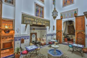 a living room filled with furniture and a fireplace at Riad Fes la Mama - Rooftop in Fez