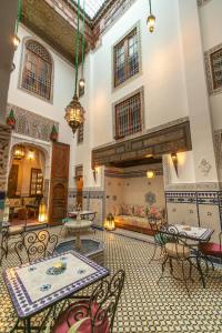 a large room with tables and chairs in a building at Riad Fes la Mama - Rooftop in Fez