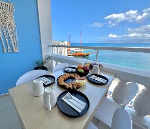 a table with a plate of food on a cruise ship at Opal Apartments Luxury by the Sea in Hersonissos