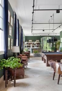 a living room with a pool table and a room with a pool table at Lofts Marambaia in Petrópolis