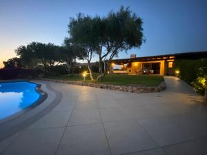 a backyard with a swimming pool and a house at Villa Carlotta in San Teodoro