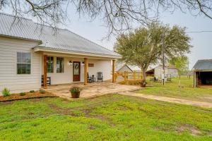 a white house with a porch and a yard at Furnished Deck and Views Rural Schulenburg Retreat in Schulenburg