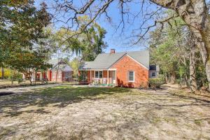 a red brick house with a yard at Golfers Getaway Mins to Masters Grill and Chill! in Augusta