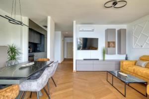 a living room with a table and a couch at Magic view - Apartment with Pool in Budva
