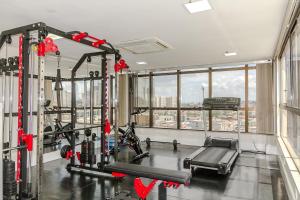 a gym with a large window and a tread machine at Brisa Tower Hotel in Ceilândia +18 photos