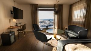 a living room with a view of the ocean at Hotel Arctic in Ilulissat