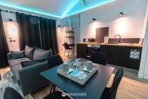 a living room with a couch and a table at Paradisier in Villars-les-Dombes