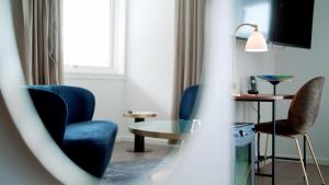 a living room with two chairs and a table at Hotel Arctic in Ilulissat