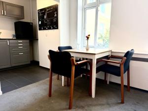 a table and chairs in a kitchen with a window at M18 in Copenhagen