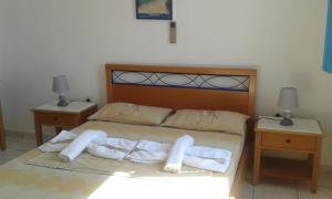 a bedroom with a bed with towels on it at Nefeli in Lefkos Karpathou