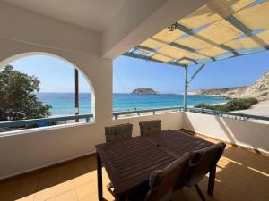 a dining room with a view of the ocean at Nefeli in Lefkos Karpathou +6 photos