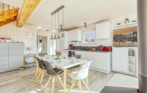 a kitchen and dining room with a table and chairs at 2 Bedroom Nice Home In Zerpenschleuse in Zerpenschleuse +20 photos