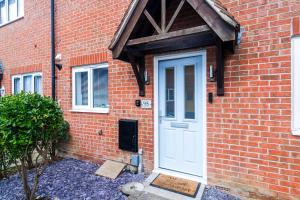 a brick house with a white door and a brick wall at Recently refurbished 2 Bed Elegant home with Parking in Harlow in Harlow