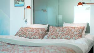 a bed with two pillows on top of it at Hotel Arctic in Ilulissat