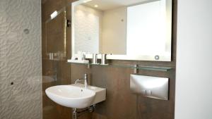 a bathroom with a sink and a mirror at Hotel Arctic in Ilulissat