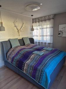 a bedroom with a bed with a blanket and a window at TOP Anbindung in den Nationalpark Eifel für 6 Personen und max 2 Hunde inklusive Terrasse in Schleiden +27 photos