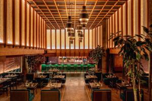 ein Esszimmer mit Tischen und grünen Stühlen in der Unterkunft CODA Williamsburg in Brooklyn