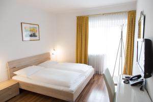 Ein Bett oder Betten in einem Zimmer der Unterkunft Salzburg Hotel Lilienhof