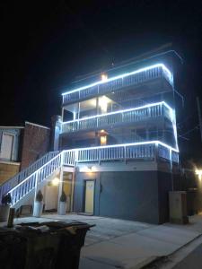 un edificio con luci blu di notte di Cozy Apartment- Quick Walk to Boardwalk & Casinos ad Atlantic City
