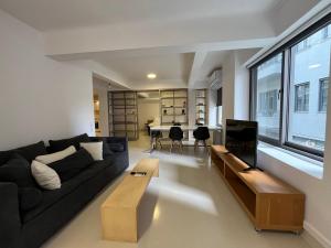 a living room with a couch and a table at Mosaikon Guesthouses #Vasilikis Str in Athens