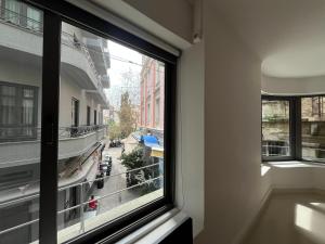 a window in a building with a view of a street at Mosaikon Guesthouses #Vasilikis Str in Athens