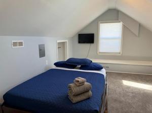 a bedroom with a bed with towels on it at The Beacon Ocean City- 7 Bedrooms, Close to All! in Ocean City
