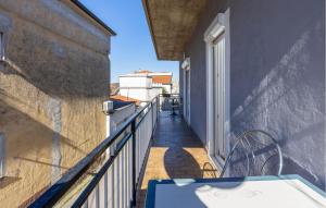 a balcony with a table and a railing at Awesome Apartment In Novi Vinodolski in Novi Vinodolski