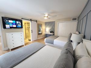 a bedroom with two beds and a flat screen tv at Blue Lagoon - Near the Boardwalk & Casinos! in Atlantic City