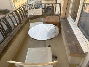 a balcony with a table and chairs on a balcony at Fully Furnished down town- 5 minutes from Lausanne Train station in Lausanne