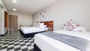 Voodi või voodid majutusasutuse Hotel Dorado Plaza Getsemaní toas