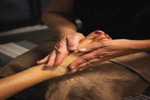 two people holding their hands on top of their legs at Bungalow in Breskens near the Beach in Breskens