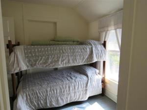 two bunk beds in a room with a window at Bay Views! Wifi Bay Side Duplex In Ship Bottom in Ship Bottom
