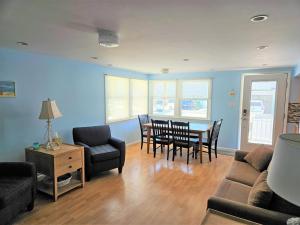 Una sala de estar con un sofá, una mesa y sillas. en Brant Beach - Lovely, 1St Floor Duplex, Only 3 Houses From The Beach No Smoking, And No Pets Permitted Property Now Has Electronic Locks - Tenant, en Brant Beach