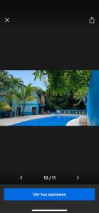 a television screen with a picture of a swimming pool at The Blue Dolphin house in Tulián