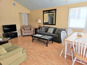 a living room with a couch and a table at Brant Beach - Lovely, 2Nd Floor Duplex, Only 3 Houses From The Beach With Great Oceanviews From Both The Livdin Area And The Deck No Smoking, And in Brant Beach