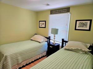 two beds in a small room with a window at Brant Beach - Lovely, 2Nd Floor Duplex, Only 3 Houses From The Beach With Great Oceanviews From Both The Livdin Area And The Deck No Smoking, And in Brant Beach